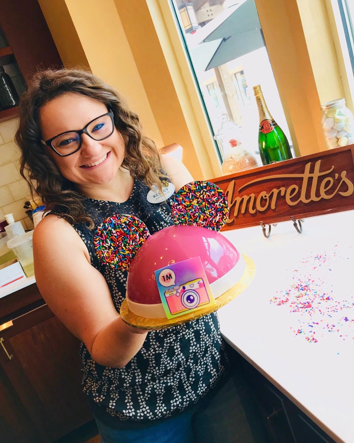 Disney Parks Blog author Kelsey Noland at Amorette’s Patisserie with celebration cake 