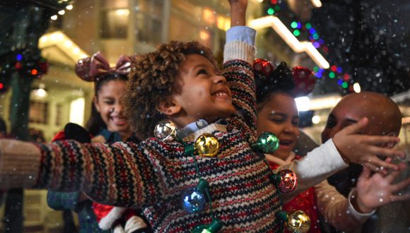 Family celebrates in the "Snow" on Main Street U.S.A. at Magic Kingdom Park