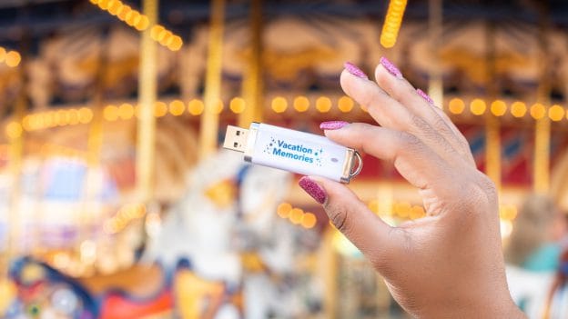 Disney PhotoPass Archive USB product in front of Prince Charming Regal Carrousel