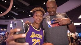 Teen Reece Henry takes a photo with former NBA player Quentin Richardson at the NBA Experience at Walt Disney World Resort