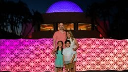 Family poses at Disney PhotoPass location in Future World near Spaceship Earth at Epcot
