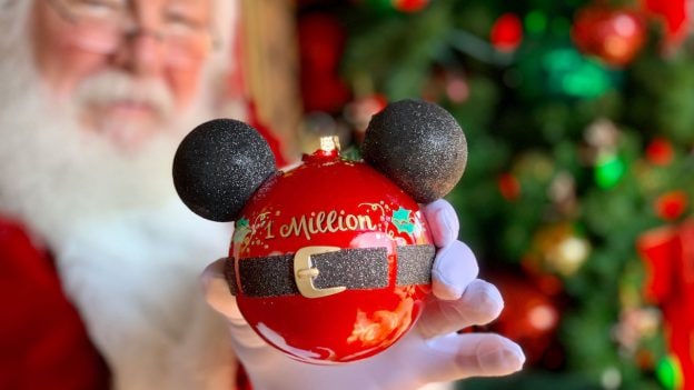 Santa holding an ornament at Disney Springs