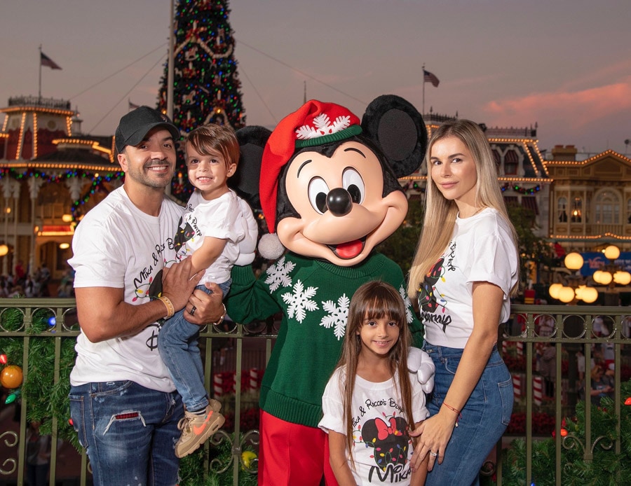 Luis Fonsi, his wife Agueda, daughter Mikaela and son Rocco pose with Mickey Mouse during Mickey's Very Merry Christmas Party at Magic Kingdom Park