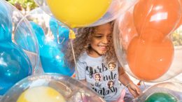 girl playing with balloons