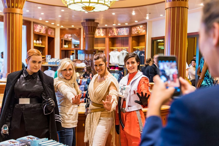 Guests dressed in Star Wars costumes pose with Ashley Eckstein