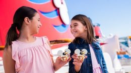 Two girls with Captain Minnie Mouse and Captain Mickey Mouse Cookies aboard Disney Cruise Line