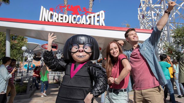 Guests pose with Edna Mode in front of the Incredicoaster at Disney California Adventure park