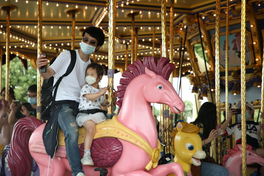 Guests ride Fantasia Carousel at Shanghai Disneyland