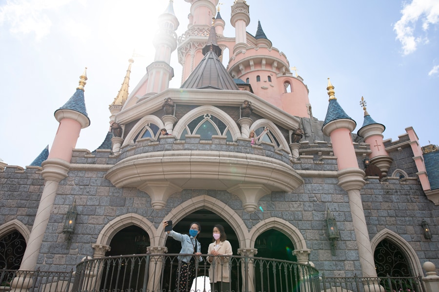 Guests take a selfie at Sleeping Beauty Castle at Disneyland Paris