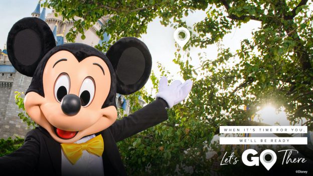 Mickey Mouse at Cinderella Castle with 'Let’s Go There' logo