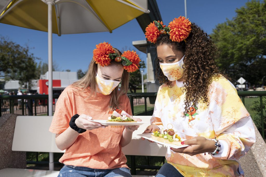 Guests trying new menu items from the Outdoor Kitchens at the Taste of EPCOT International Flower & Garden Festival