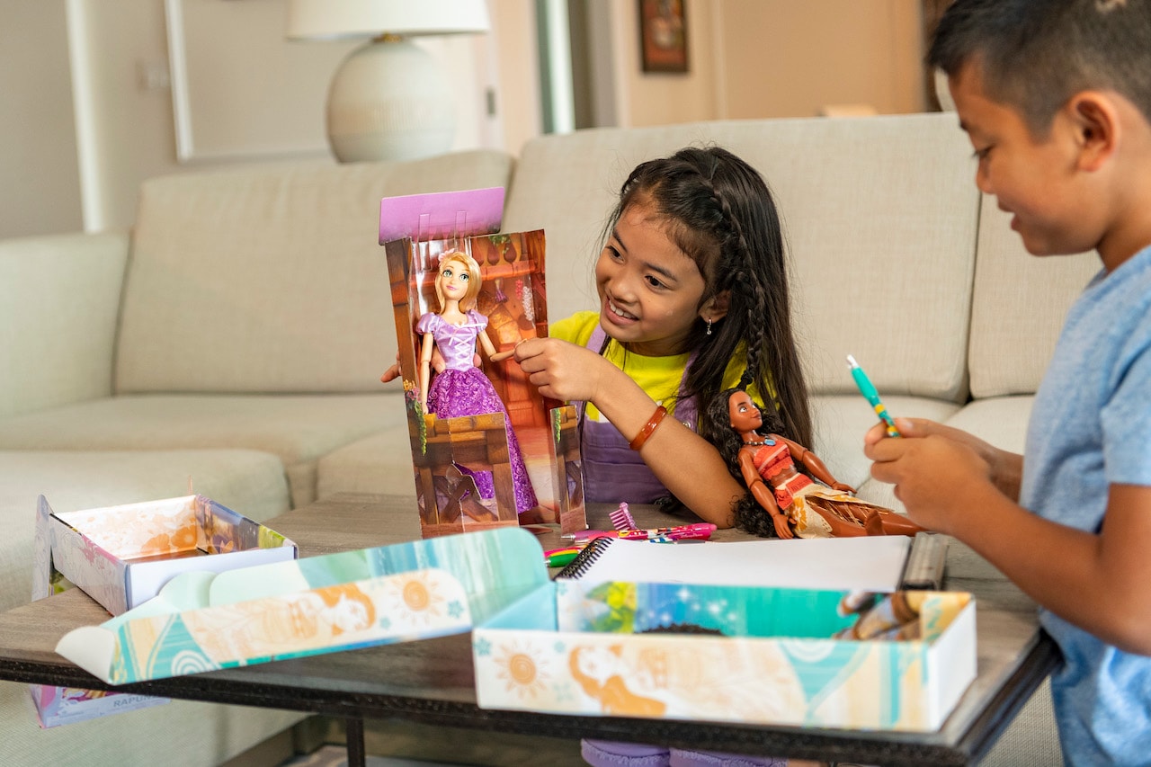 Girl playing with shopDisney doll
