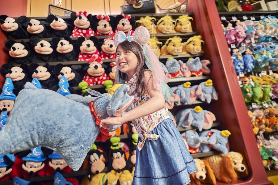 Girl with Disney plushes at Shanghai Disneyland Resort