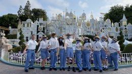 Disneyland Resort cast members in front of "it's a small world"