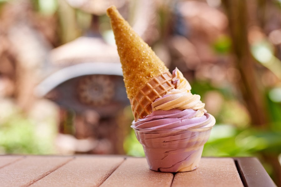 “Tamatoa-inspired” Dipped Cone with DOLE Whip raspberry swirled with DOLE Whip orange in a white chocolate-dipped waffle cone coated with “shiny” gold sugar.