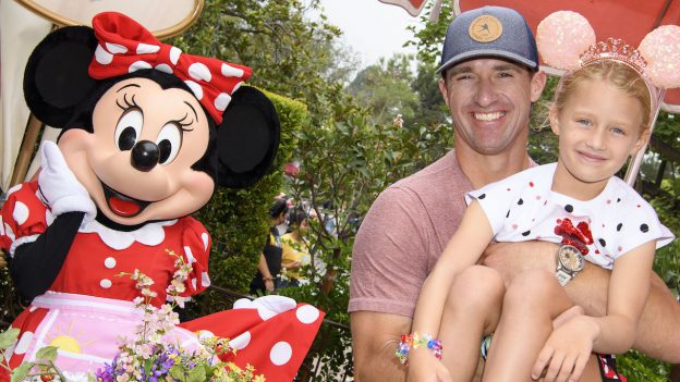Legendary football player Drew Brees poses with his daughter Rylen while celebrating her 7th birthday during “Minnie & Friends – Breakfast in the Park” at Disneyland Park