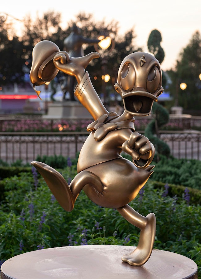 Donald Duck at Magic Kingdom Park is one of the “Disney Fab 50” golden character sculptures