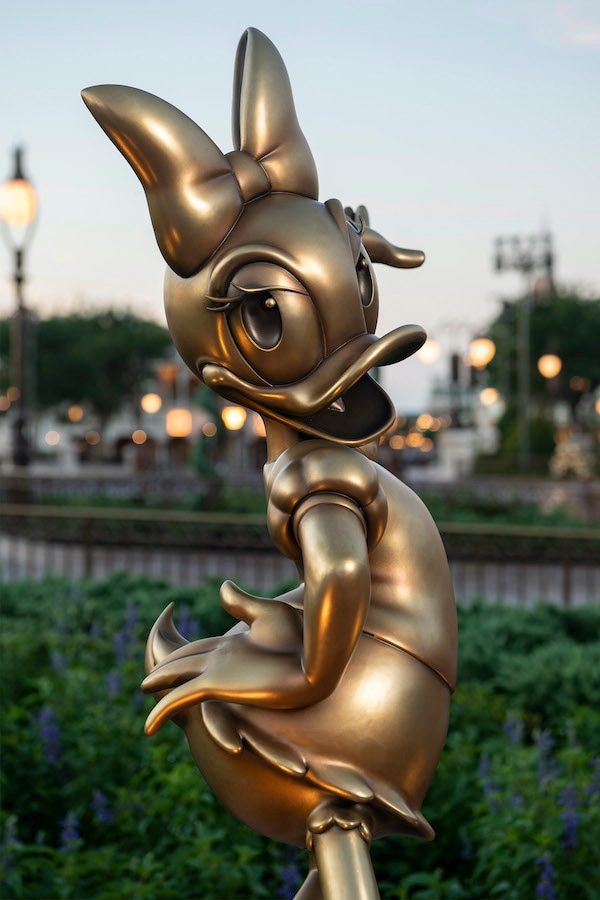 Daisy Duck at Magic Kingdom Park is one of the “Disney Fab 50” golden character sculptures