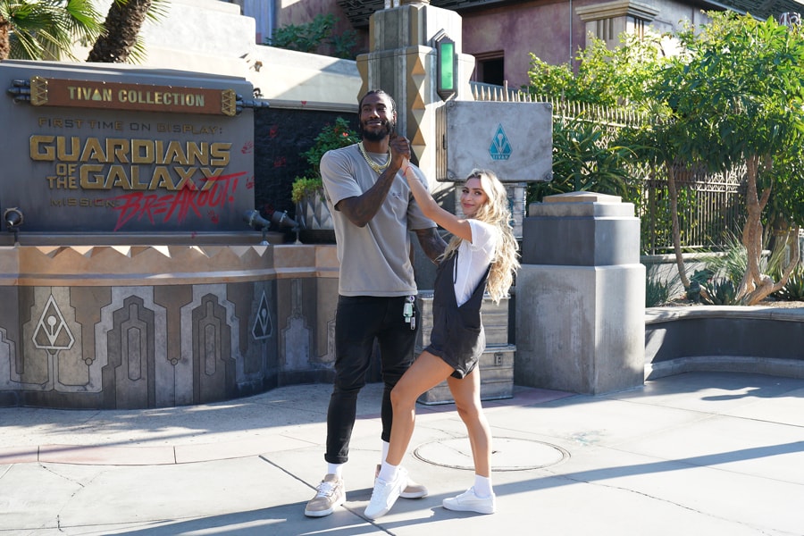 Iman Shumpert and Daniella Karagach strike a pose in front of Guardians of the Galaxy: Mission Breakout at Disney California Adventure park before 