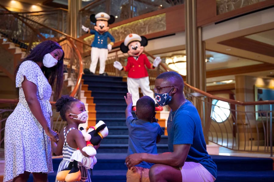 Family on a Disney cruise watching Mickey Mouse and Minnie Mouse