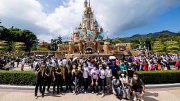 Cast members and athletes in front of Castle of Magical Dreams