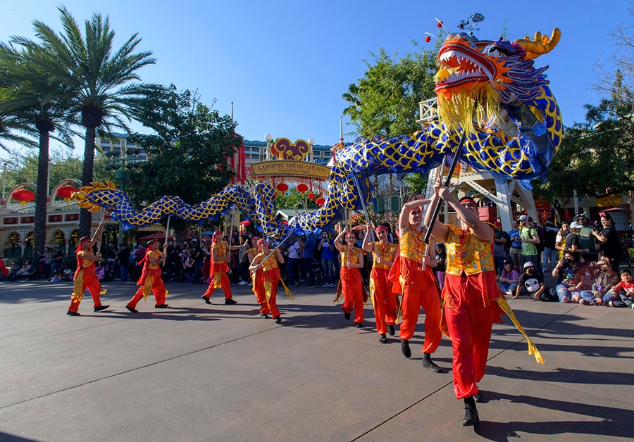 perforers holding a dragon puppet during Mulan's Lunar New Year Proession at Disney California Adventure 
