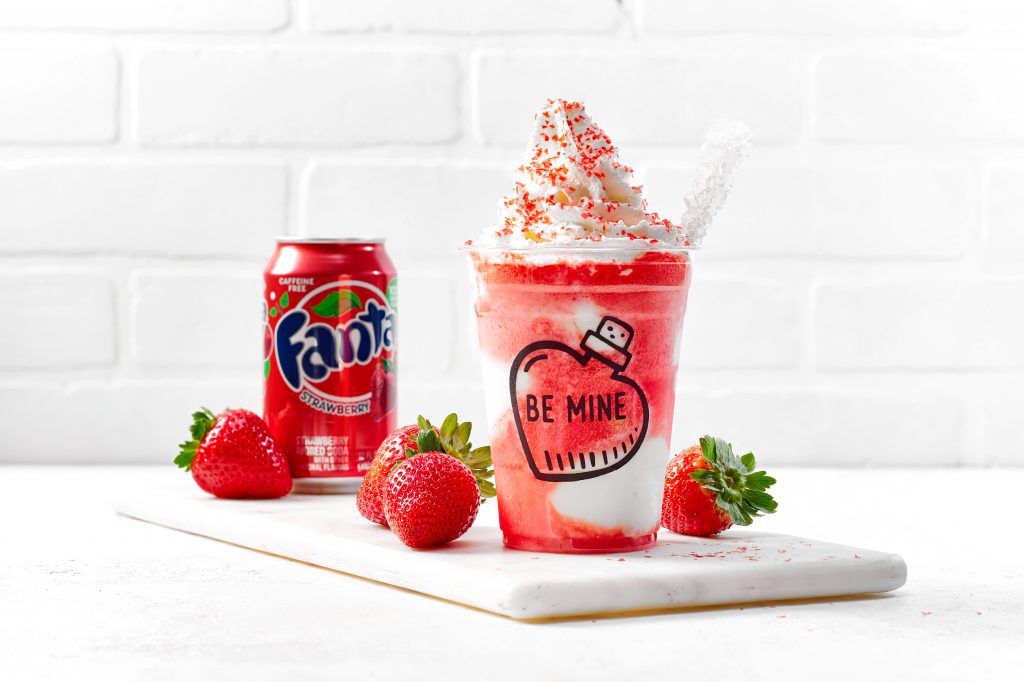gelato shake with whipped cream and a can of strawberry Fanta