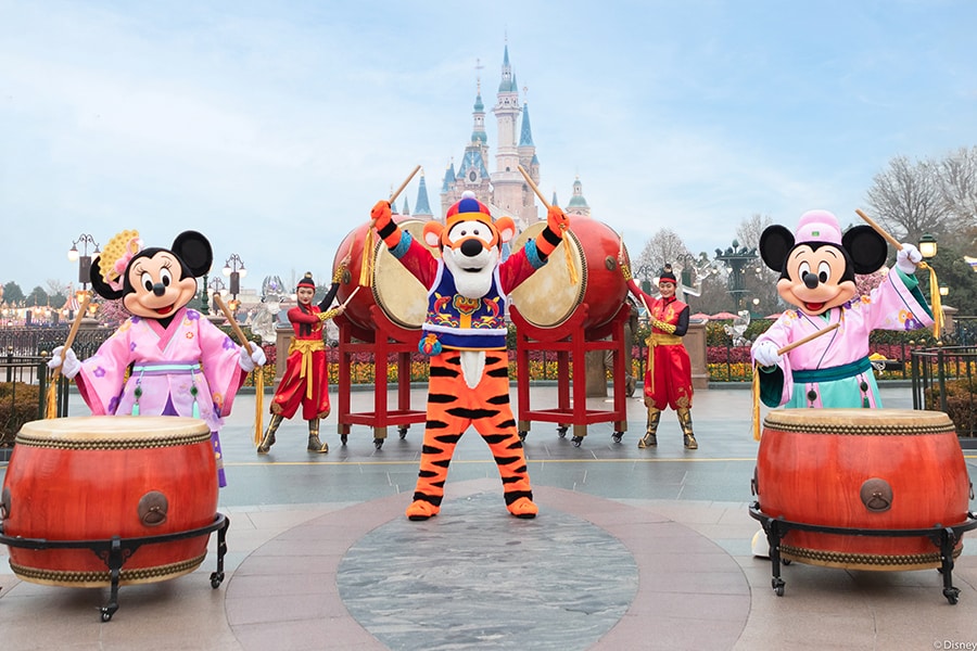 mickey and minnie mouse with tigger outside the castle at shangai disney resort