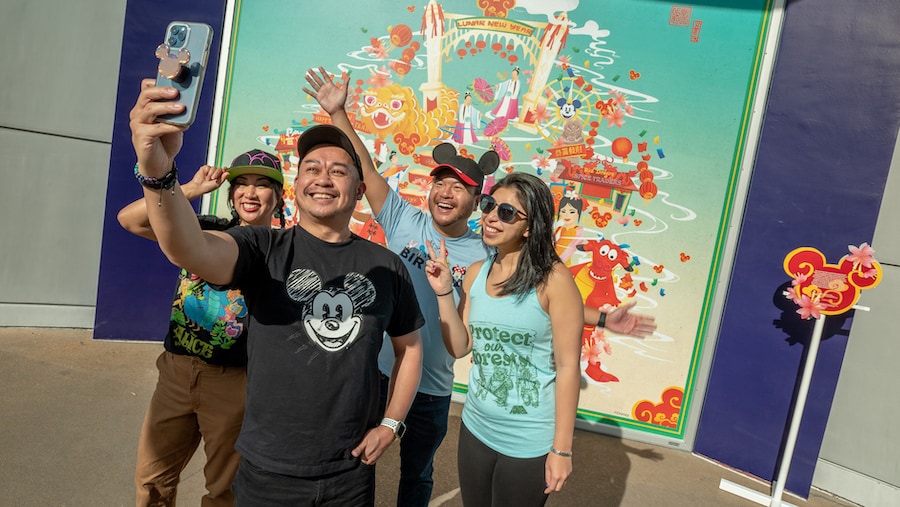 Guests in front of the Lunar New Year mural created by Disney Live Entertainment Associate Art Director Elizabeth Lisa Kang