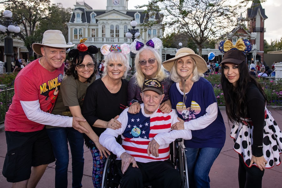 The McCroskey family with WWII Veteran William McCroskey who celebrated his 100th birthday in Magic Kingdom Park on Feb 18, 2022
