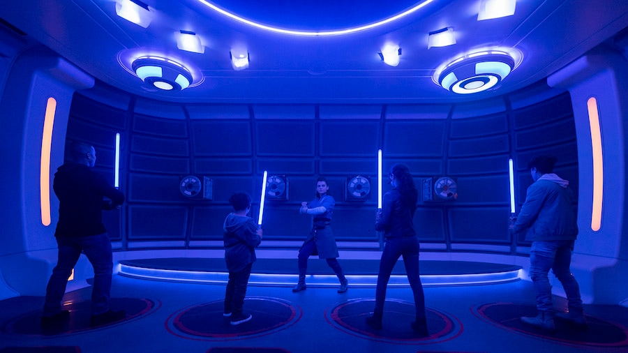 Passengers learn the ancient art of wielding a lightsaber in the Lightsaber Training Pod onboard the Halcyon starcruiser in Star Wars: Galactic Starcruiser 