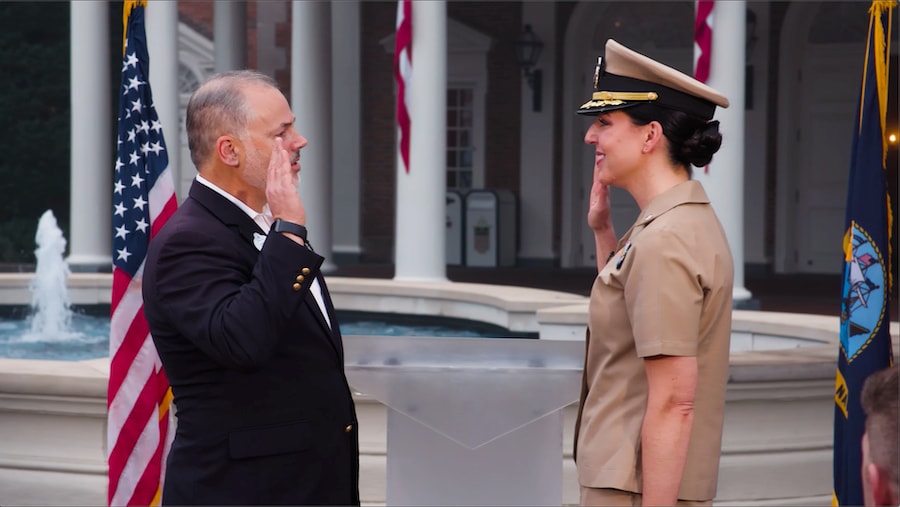 Disney Cast Member and Veteran, Cappy Surette admisters the oath of office with U.S. Navy Cmdr. Laura Stegherr.