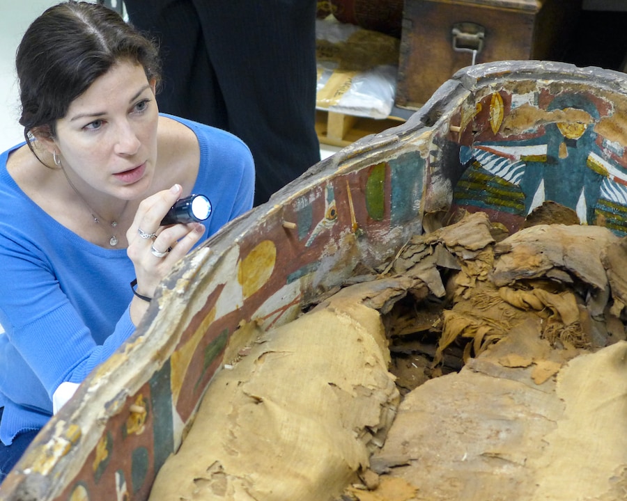 Dr. Kara Cooney examining a sarcophagus Credit: Marissa Stevens