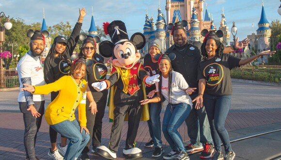 Drum Major Mickey and HBCU Alum in front of Cinderella's Castle
