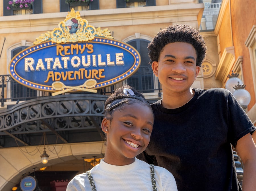 Kyrie Mcalpin and Andre Robinson in front of Remy’s Ratatouille Adventure at EPCOT