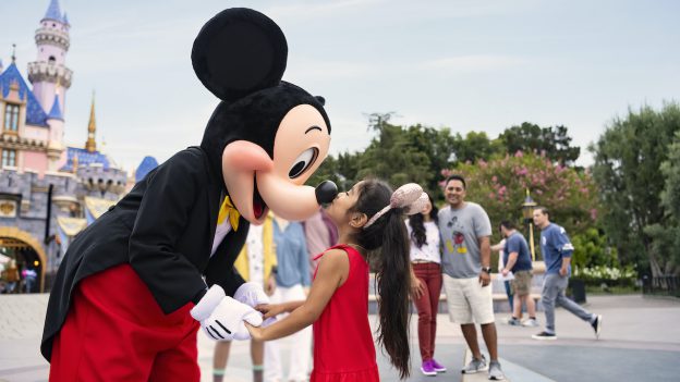 Young guest meeting Mickey Mouse at Disneyland part