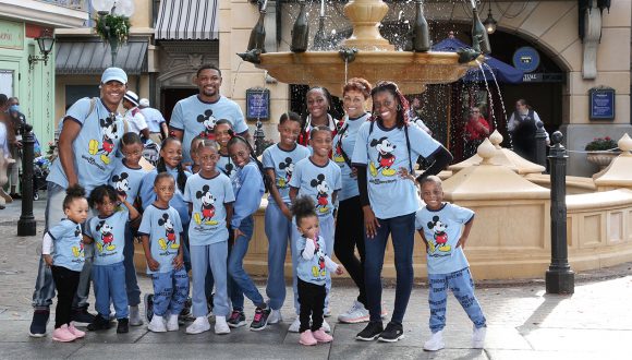 Family in blue Mickey Mouse t-shirts outside of remy's ratatouille adventure