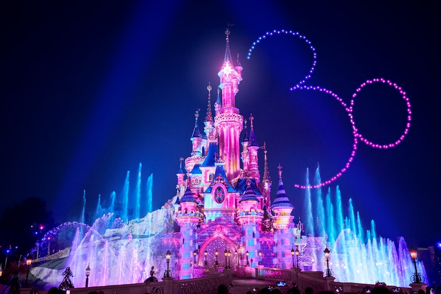 Disney D-Light shows 150 synchronized drones soaring above Sleeping Beauty Castle to form the resort’s 30th Anniversary logo