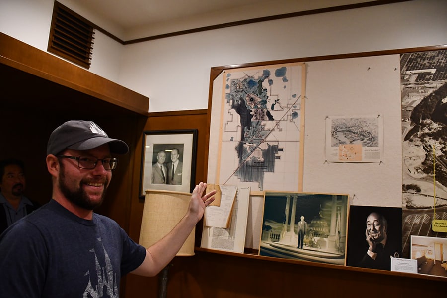 Cast member Ben points to an early master plan of the Walt Disney World property in Walt Disney's working office