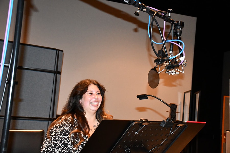 Cast member Olivia in a recording studio at The Walt Disney Studios