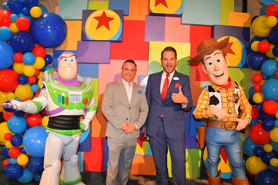 Cast members Ron and Nicholas at Paradise Pier Hotel pose with Woody and Buzz to celebrate the announcement of the hotel's all-new theme