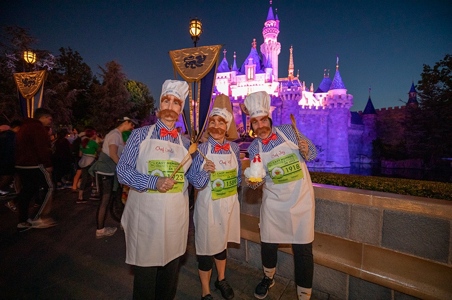 Disneyland Resort cast members pose in front of Sleeping Beauty Castle during their race