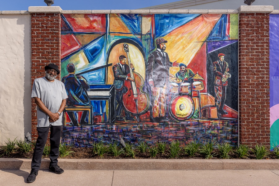 Orlando Artist Everett Spruill in front of his artwork at Disney Springs