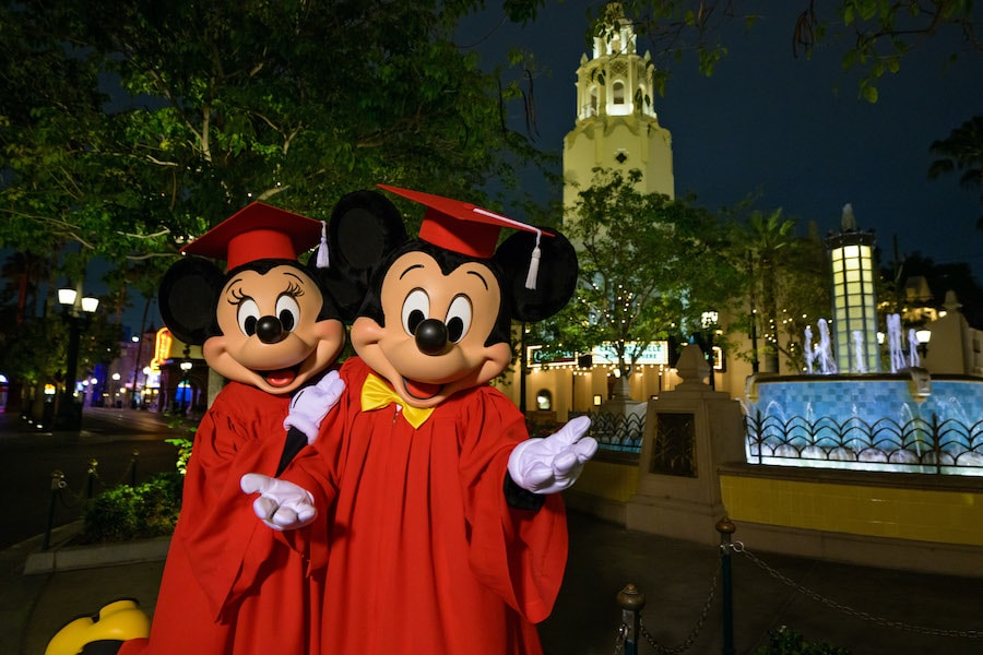 Mickey Mouse and Minnie Mouse in their graduation cap and gown outfits