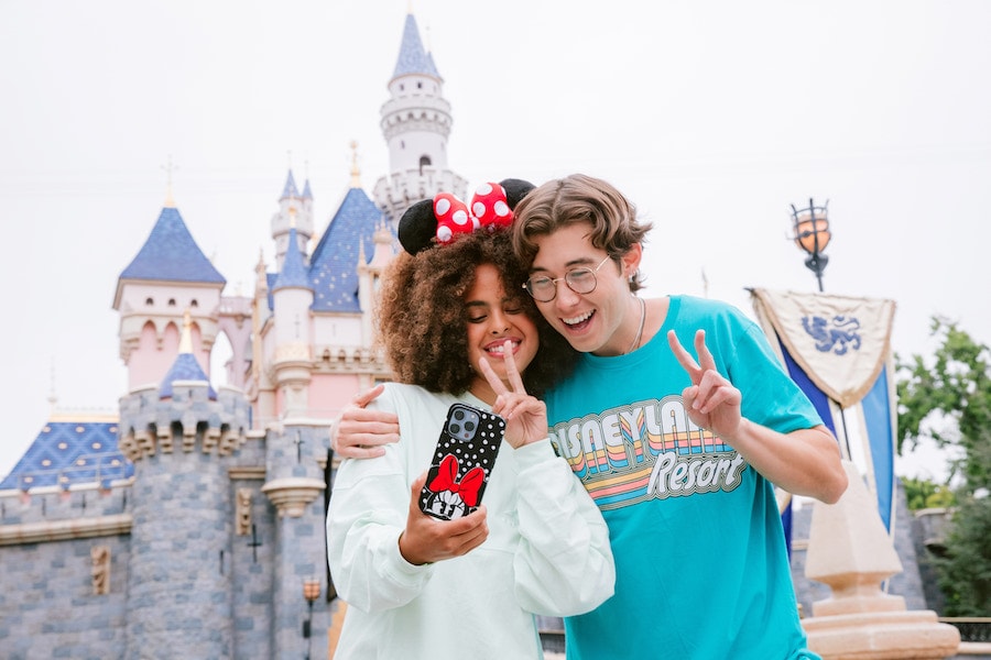 Couple at Disneyland park with an OtterBox phone case