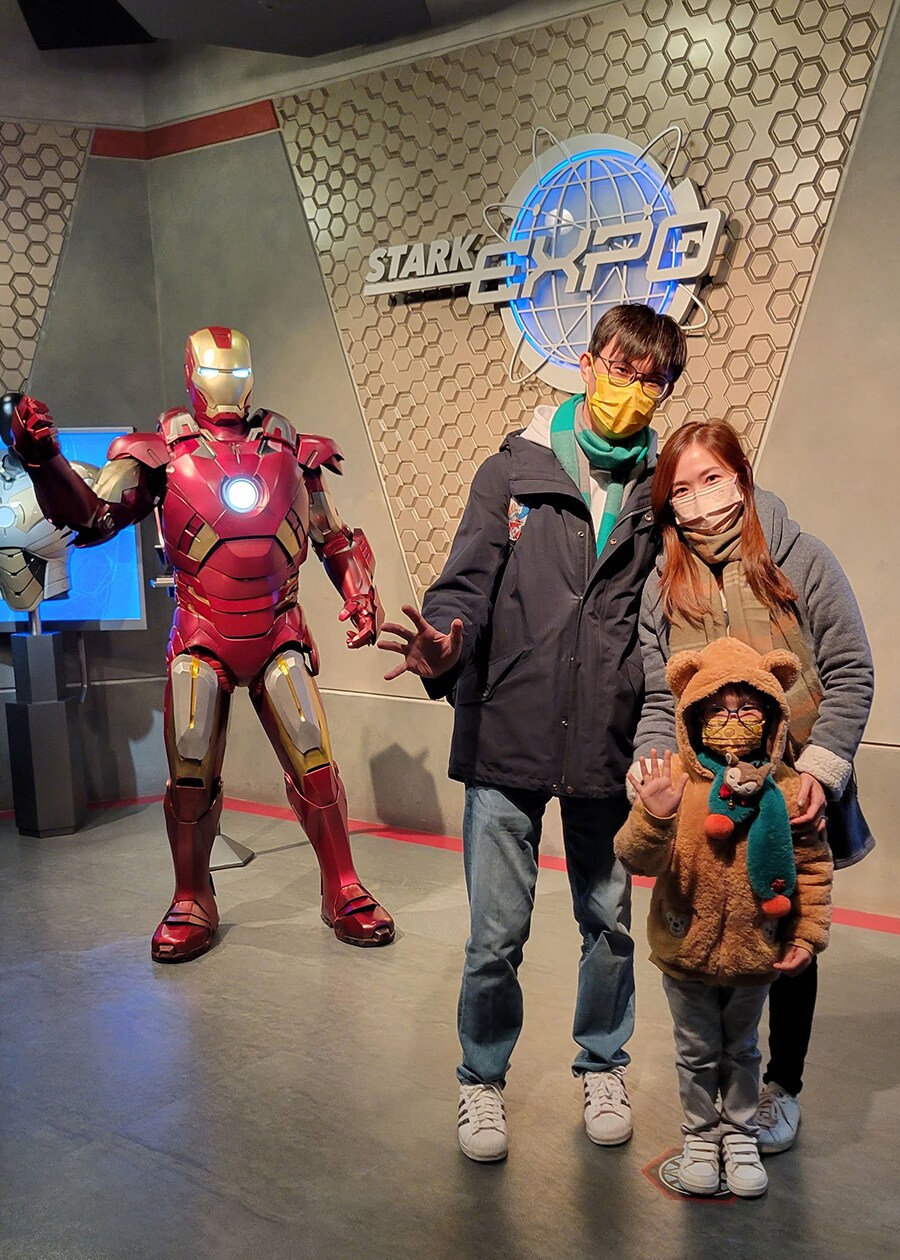 Kingsley with wife and child in front of Iron Man
