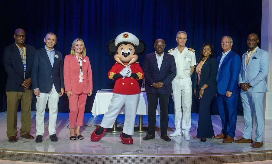 Disney leadership and representatives of The Bahamas pose with Captain Minnie Mouse at the plaque and key exchange ceremony