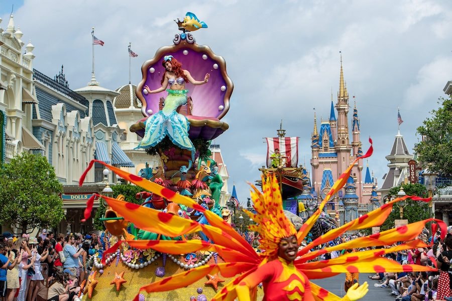 Ariel waves to guests during the "Disney Festival of Fantasy Parade" in Magic Kingdom Park at Walt Disney World Resort