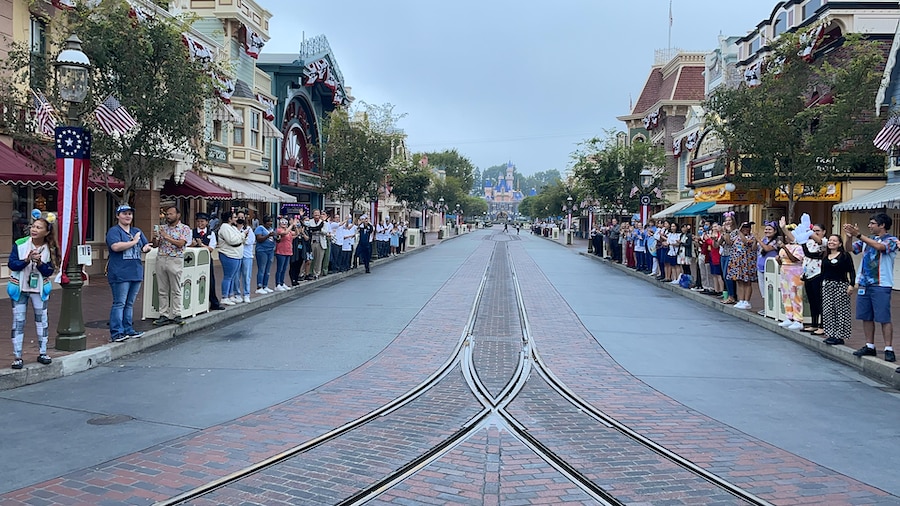Disneyland Resort cast members doing the WelcomeEARS tradition along Main Street, U.S.A., greeting guests as they entered the park for the 67th anniversary