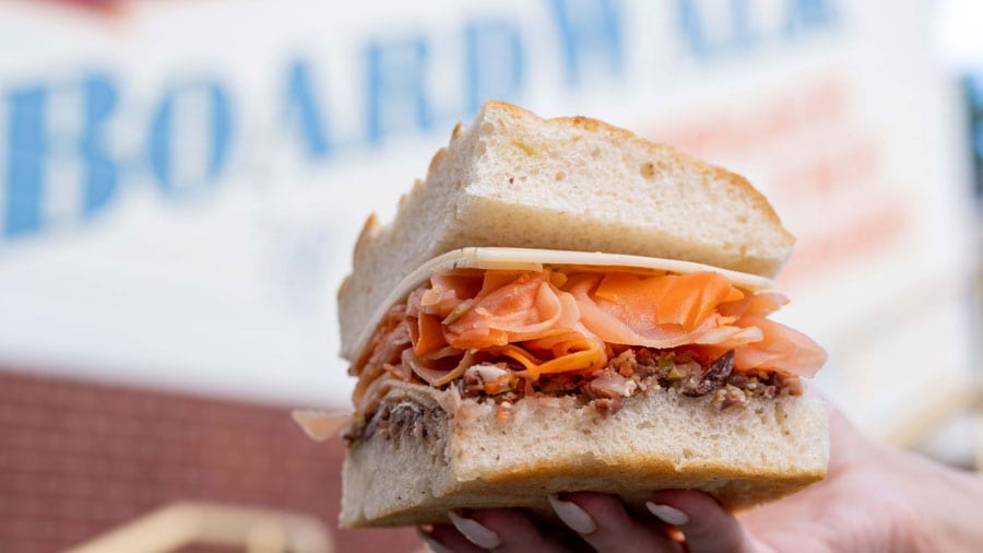 This is the Veggie Crunch Muffaletta which is stacked with cured and pickled root vegetables, an olive-giardiniera tapenade and plant-based cheese, served on focaccia.